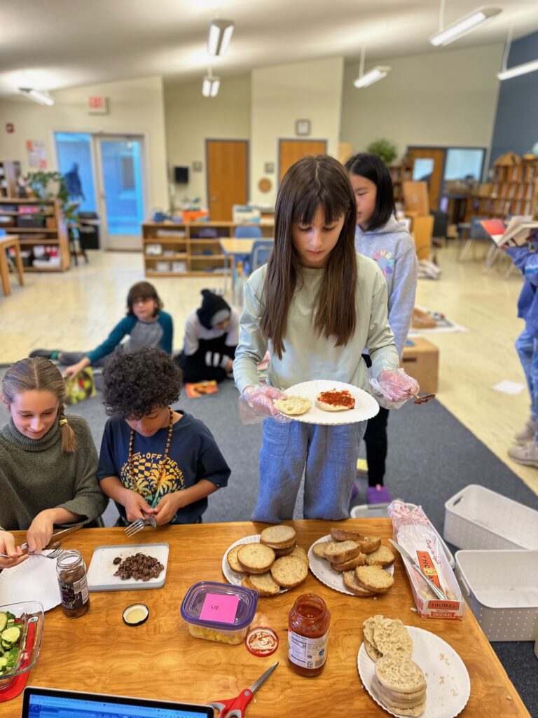 Students serve themselves for Pi day lunch at Chesapeake Montessori School