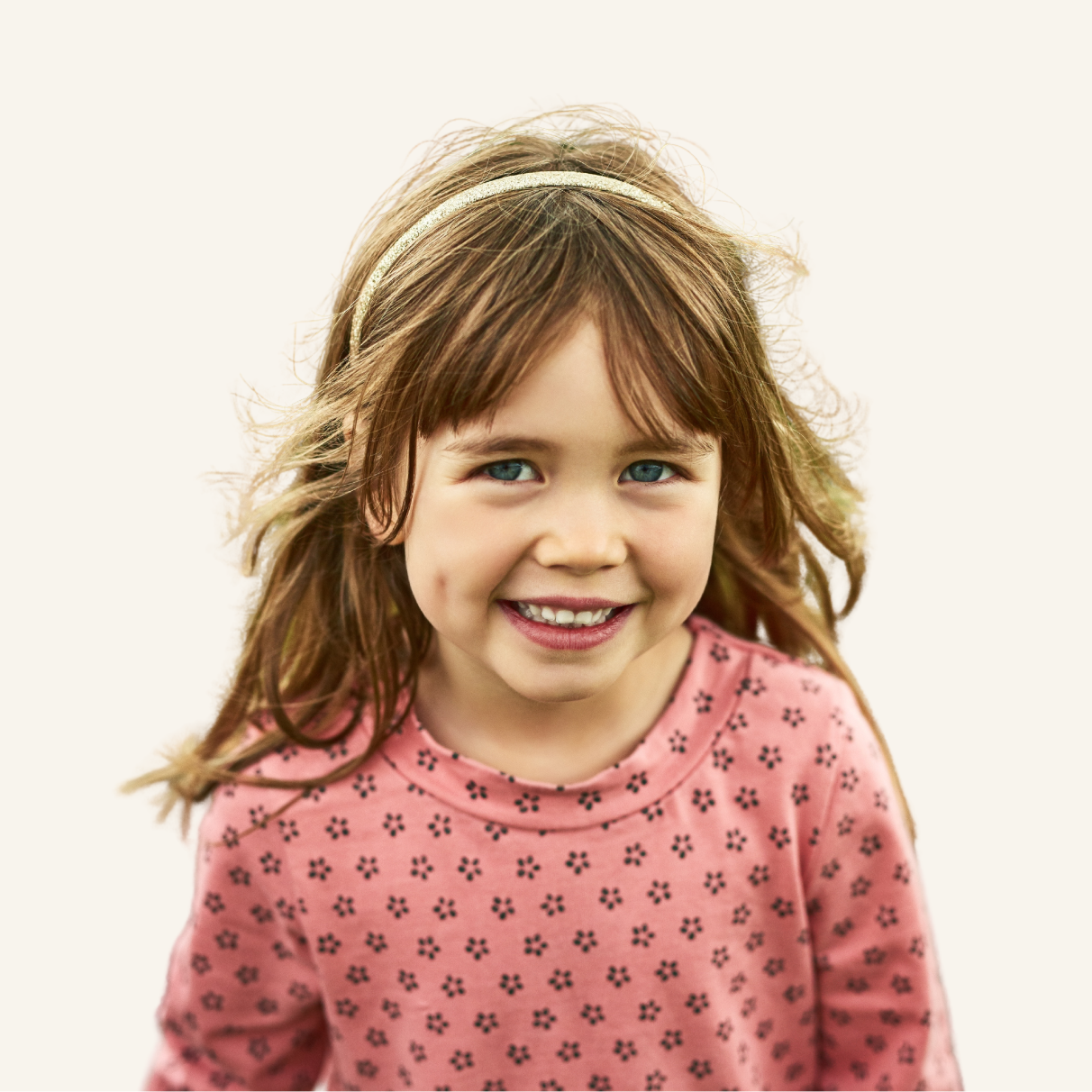A young girl smiling.