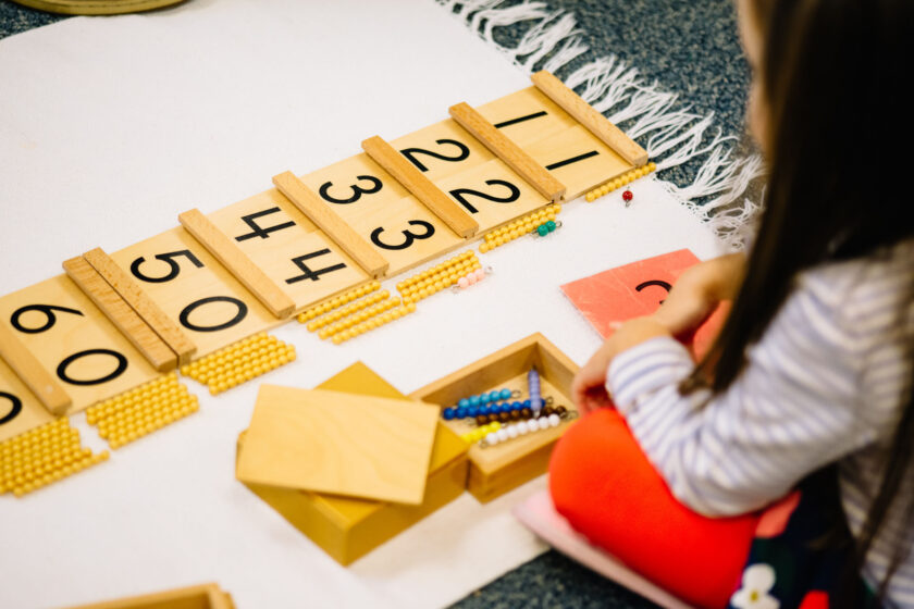 A child with number cards.